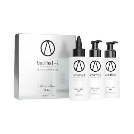 A silver ArmorPlex Restructuring Treatment box stands beside three white pump-top bottles with matching logos, all Hair Bar NYC products. Designed for after-care and salon use, they're displayed against a white background.