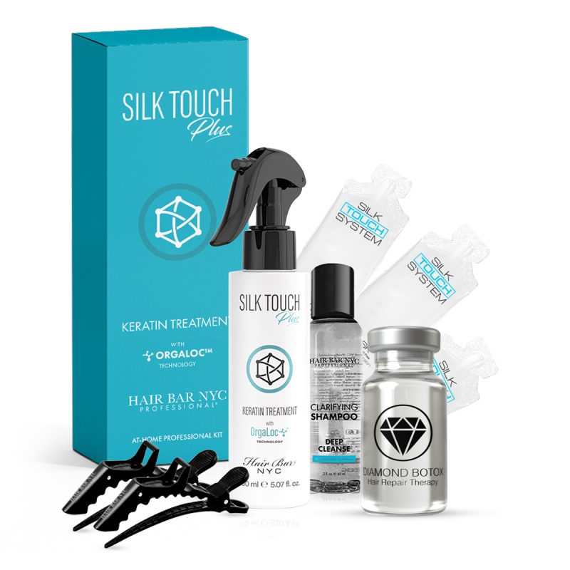 The Premium Vegan Keratin Home Kit includes a turquoise “Silk Touch Plus Keratin Treatment” box, spray bottle, clarifying shampoo, Diamond Botox vial, ampoules, and four black hair clips arranged together.