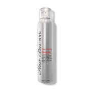 A sleek silver aerosol can of Stay Perfect hairspray stands upright, featuring black and red text for branding and product details. The design is modern with a translucent cap.
