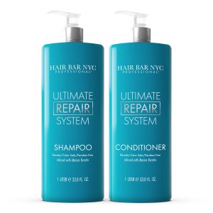 Two tall teal bottles from the Ultimate Repair System Duo Bundle are shown side by side—shampoo on the left and conditioner on the right. Both are keratin, color safe, paraben free, and have white pump dispensers.